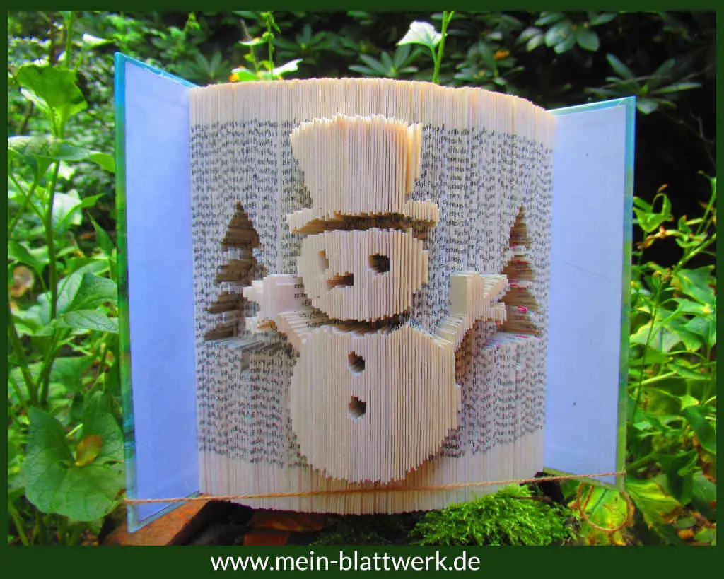 Bastel-Vorlage zu Weihnachten. Einen Schneemann in ein Buch gefaltet. Schöne Weihnachtsdeko.